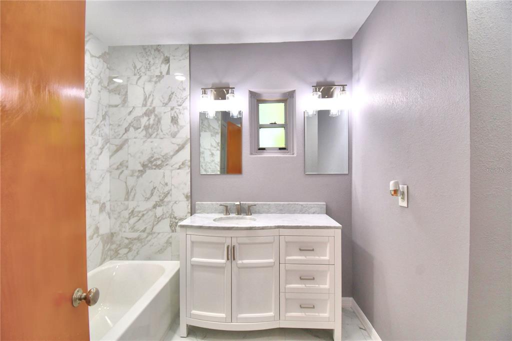 1475 Lake Howard Drive Southwest Winter Haven, FL 33880 - Photo 11 of 25 a bathroom with a sink and a mirror