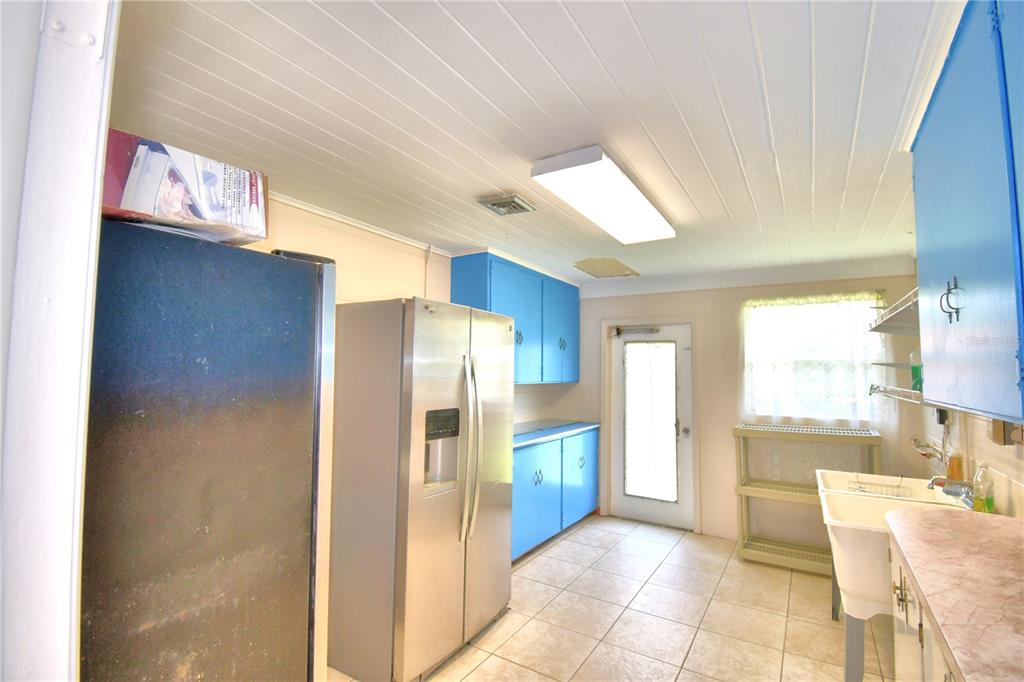 1475 Lake Howard Drive Southwest Winter Haven, FL 33880 - Photo 17 of 25 a view of a kitchen with refrigerator and window