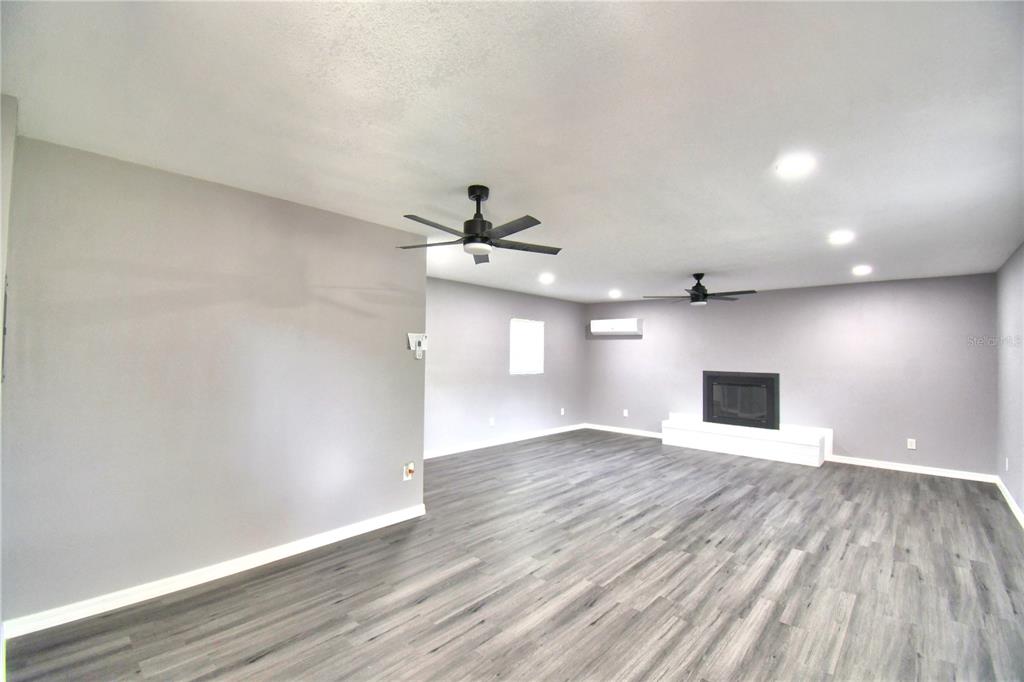 1475 Lake Howard Drive Southwest Winter Haven, FL 33880 - Photo 19 of 25 a view of an empty room with window and wooden floor
