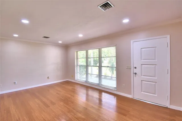 wooden floor in an empty room with a window