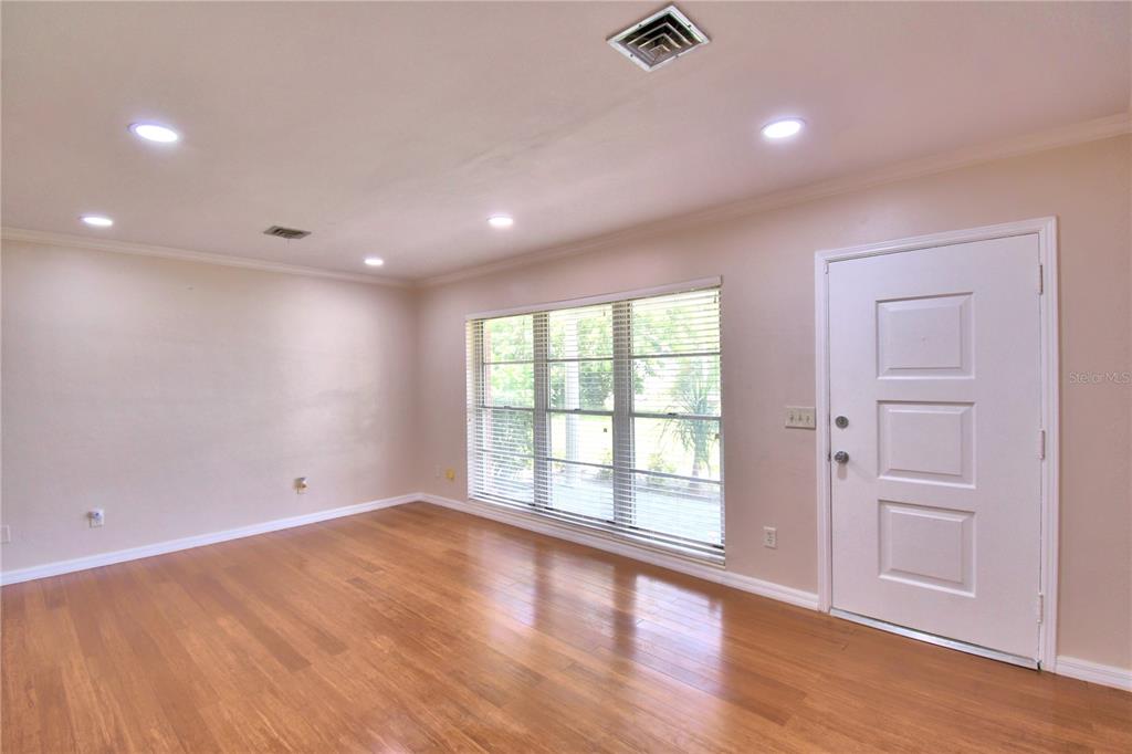 1475 Lake Howard Drive Southwest Winter Haven, FL 33880 - Photo 7 of 25 wooden floor in an empty room with a window