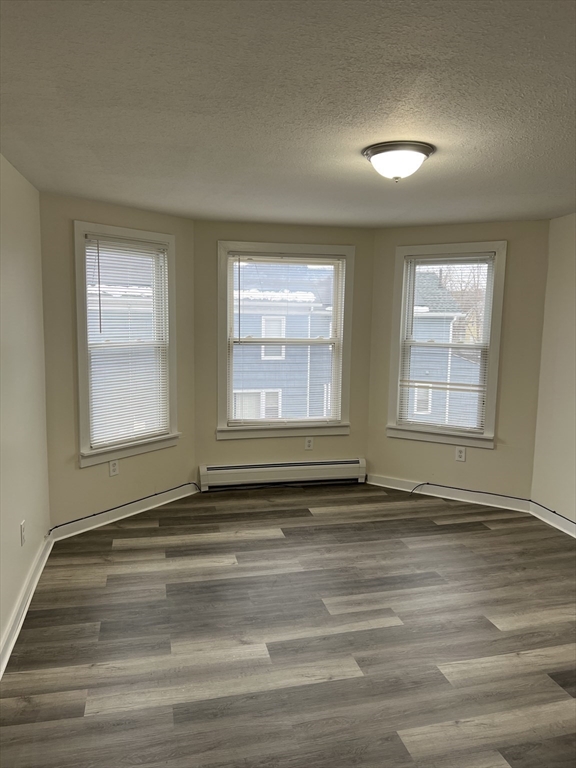 93 Florence Street Springfield, MA 01105 - Photo 4 of 9 a view of empty room with wooden floor and fan