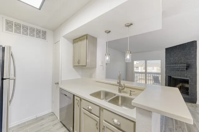 a kitchen with a sink and a refrigerator
