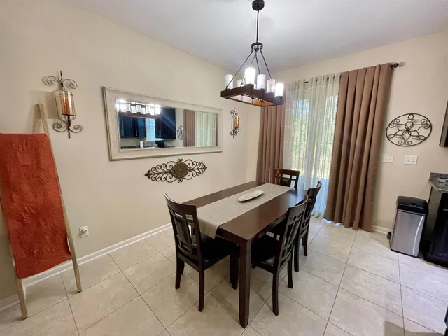 a view of a dining room with furniture and chandelier