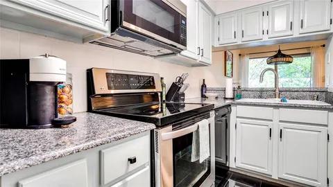 a kitchen with stainless steel appliances granite countertop a refrigerator stove and microwave
