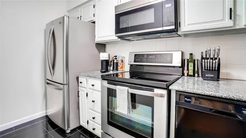 a kitchen with stainless steel appliances granite countertop a sink and cabinets