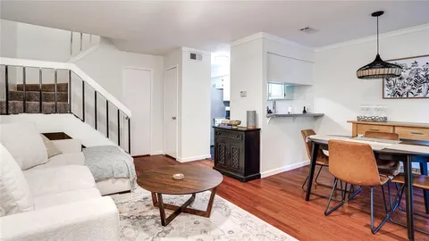 a living room with furniture and a dining table