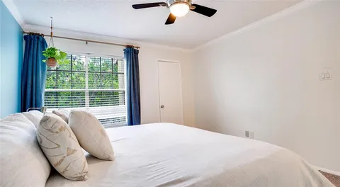 a spacious bedroom with a bed and a window