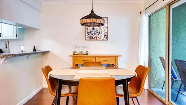 a dining room with furniture and window