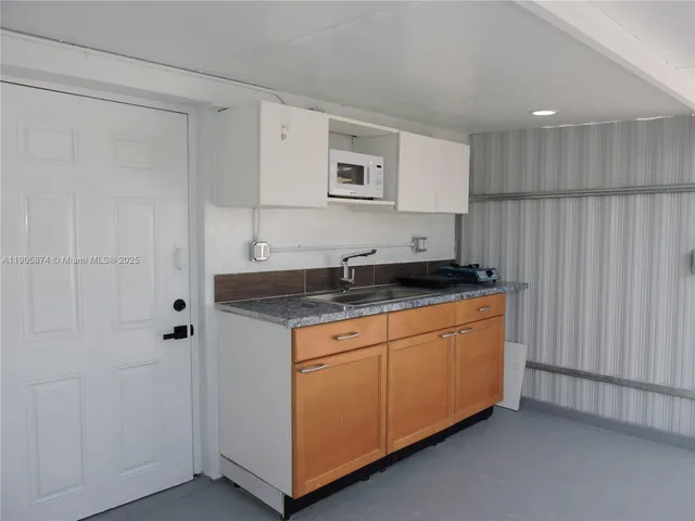 a kitchen with granite countertop cabinets and sink