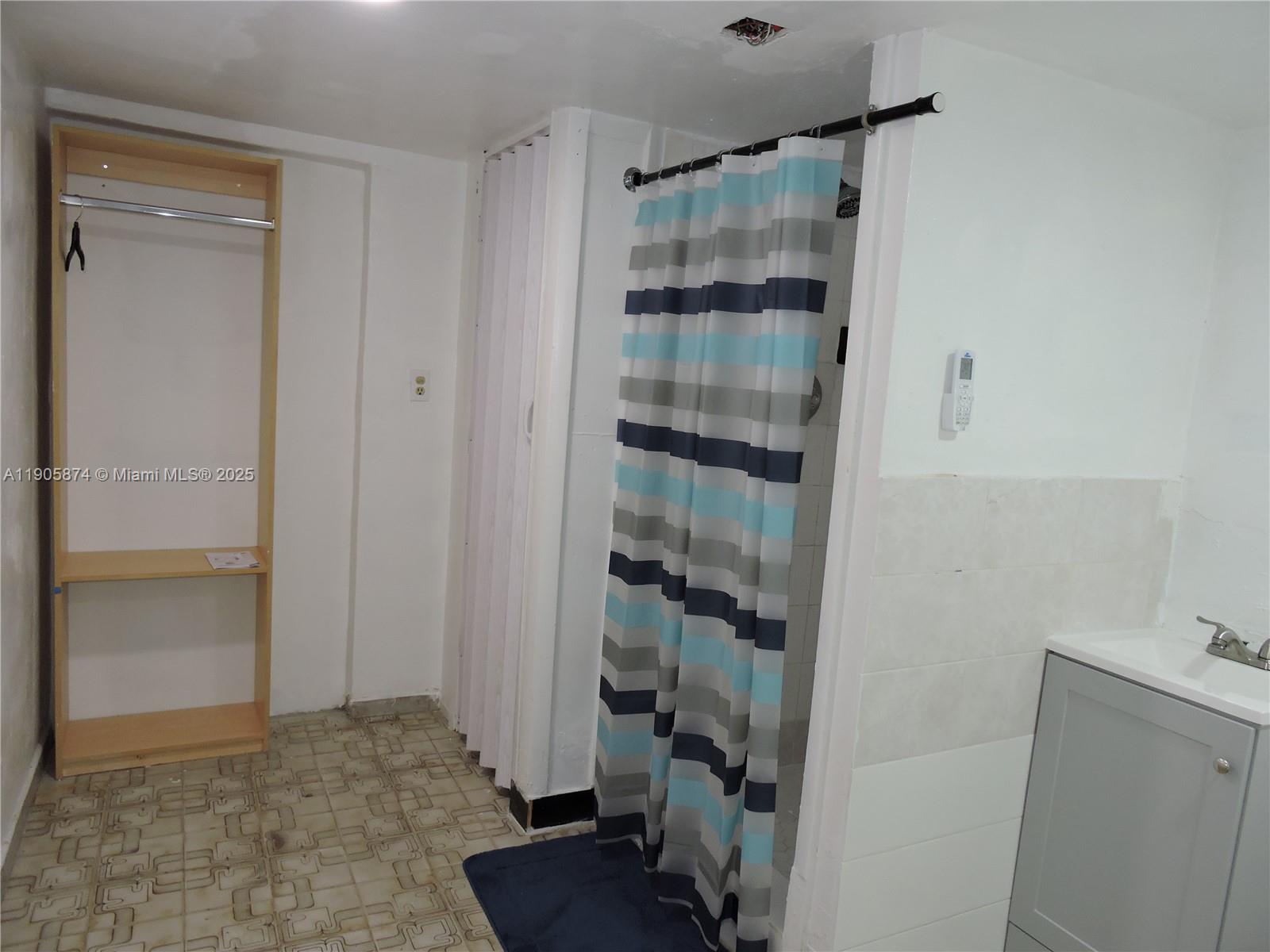 5451 West 10th Avenue, Unit 5 Hialeah, FL 33012 - Photo 5 of 26 a view of a bathroom with a tub and shower