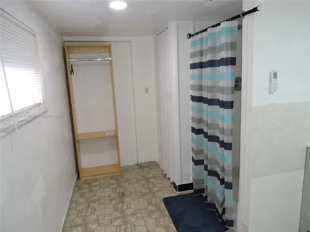 a view of a hallway with wooden floor and closet