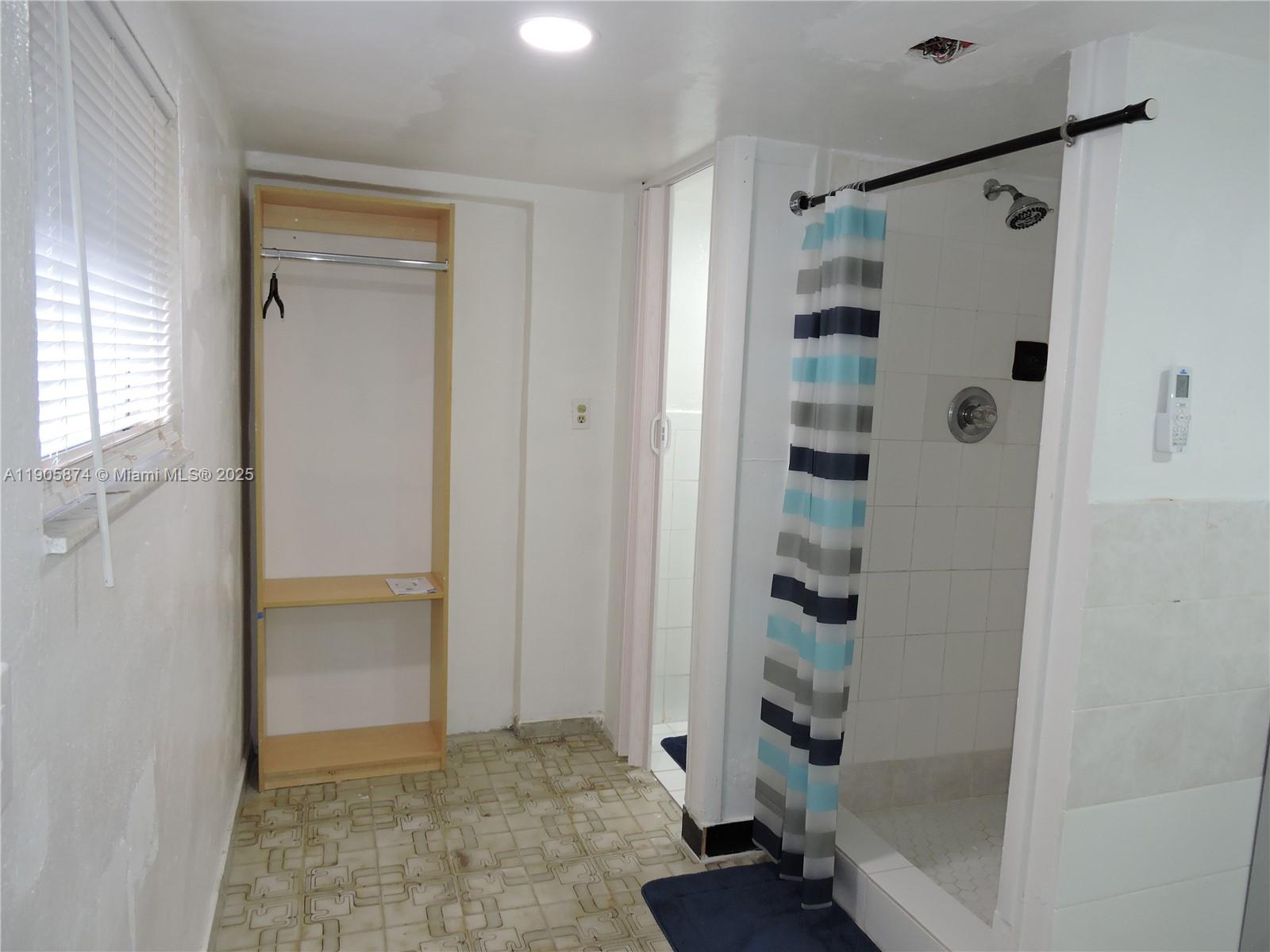 5451 West 10th Avenue, Unit 5 Hialeah, FL 33012 - Photo 8 of 26 a bathroom with a shower and a glass door