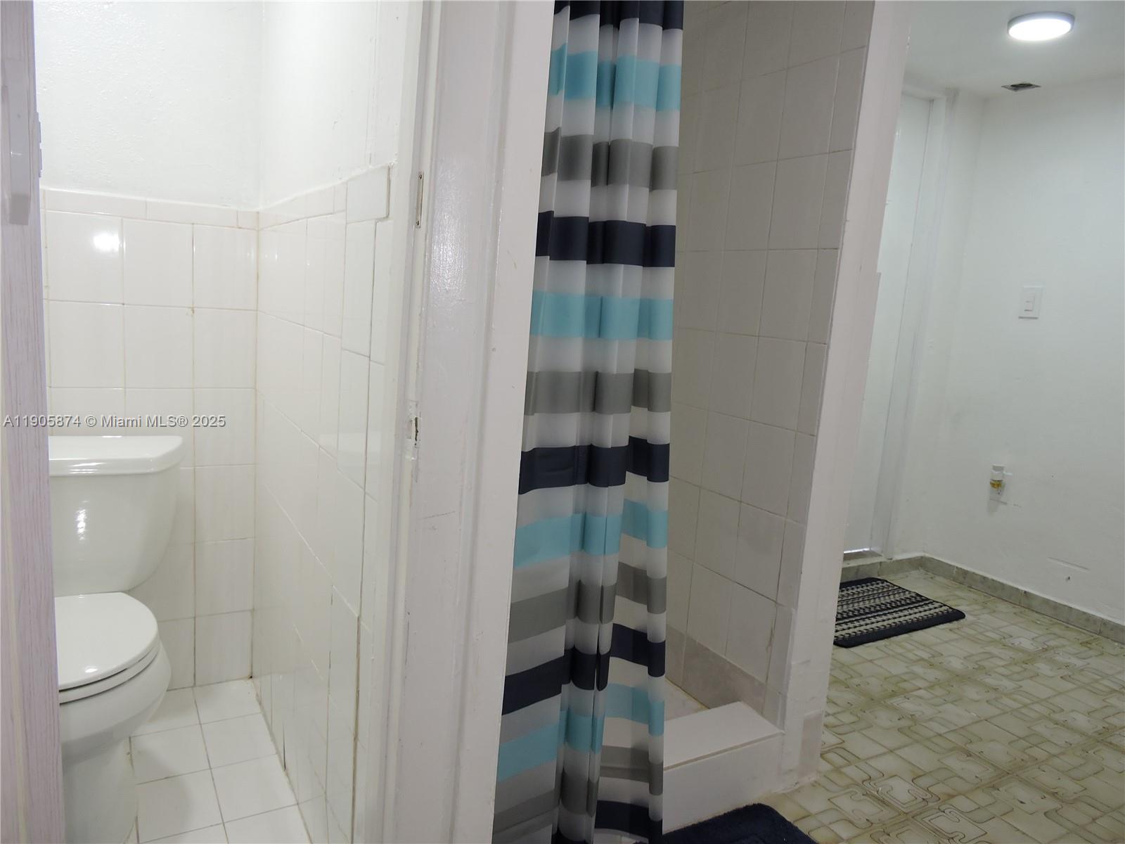 5451 West 10th Avenue, Unit 5 Hialeah, FL 33012 - Photo 9 of 26 a bathroom with a granite countertop shower and a toilet