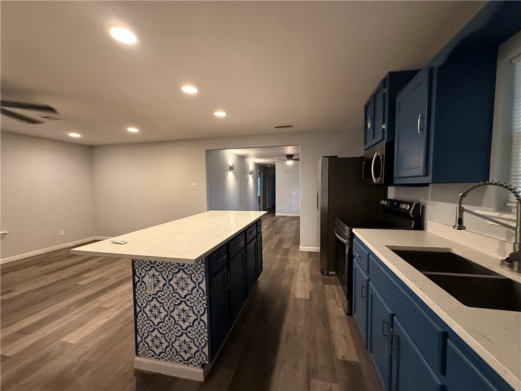 917 Corazan Street Alice, TX 78332 - Photo 13 of 37 a kitchen with granite countertop a sink a counter top space stainless steel appliances and cabinets