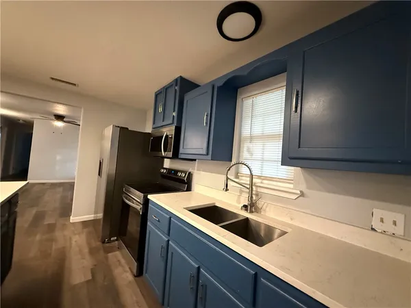 a kitchen with refrigerator a sink and dishwasher