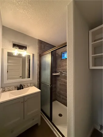 a bathroom with a shower and a sink