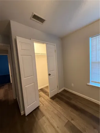 a view of an empty room and wooden floor