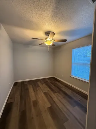a view of an empty room and wooden floor
