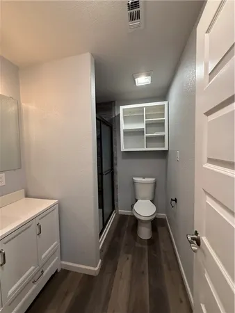 a bathroom with a glass door shower and sink