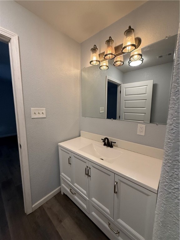 917 Corazan Street Alice, TX 78332 - Photo 37 of 37 a bathroom with a light fixture a sink and mirror