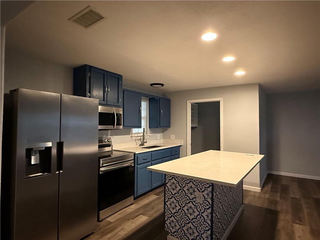 917 Corazan Street Alice, TX 78332 - Photo 4 of 37 a kitchen with stainless steel appliances a refrigerator sink and stove