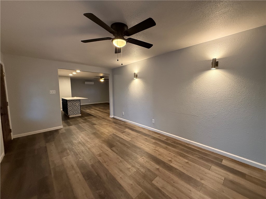 917 Corazan Street Alice, TX 78332 - Photo 6 of 37 an empty room with wooden floor and windows