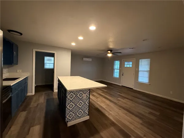 a kitchen with a stove a sink and a refrigerator