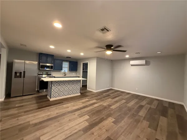 an open kitchen with kitchen island a sink stainless steel appliances and cabinets