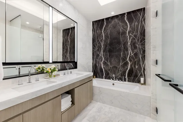 a bathroom with a double vanity sink and a mirror