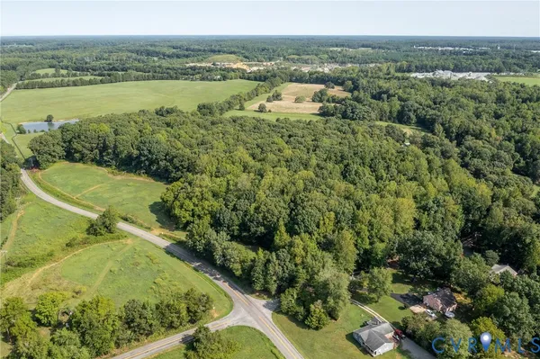 an aerial view of a houses with a yard