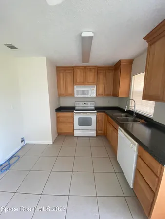 a kitchen with stainless steel appliances a sink stove and cabinets