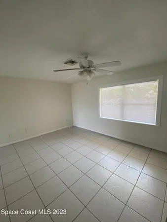 a view of an empty room and a window