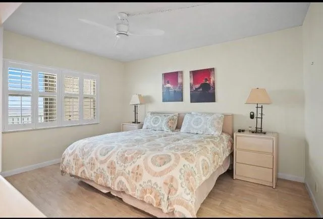 a bedroom with a bed and a painting on the wall
