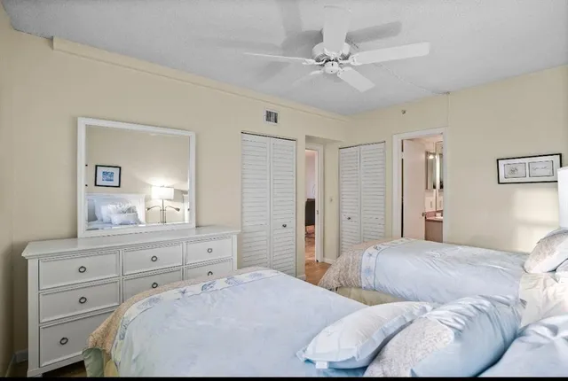 a bedroom with a bed and a mirror on dresser