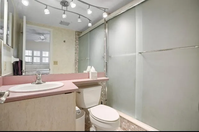 a bathroom with a sink toilet and shower