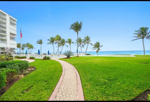a view of a garden with a building in the background