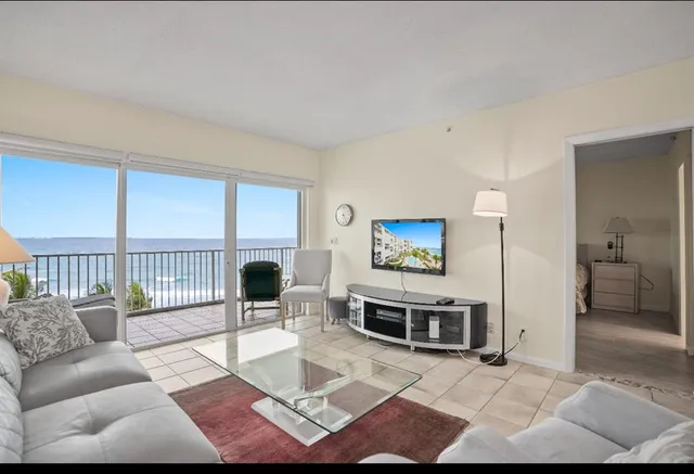 a living room with furniture a rug and a flat screen tv