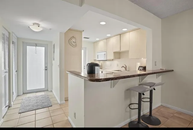 a kitchen with stainless steel appliances granite countertop a sink and cabinets