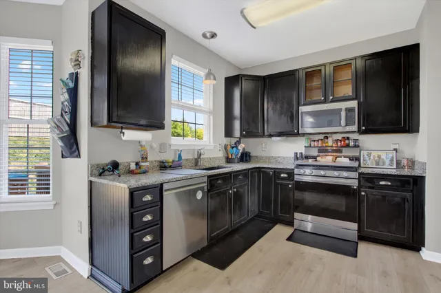 a kitchen with a refrigerator stove and sink