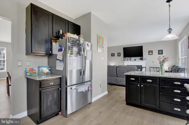 a kitchen with granite countertop a sink and a window
