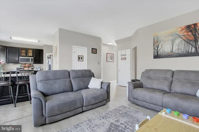 a living room with furniture fireplace and flat screen tv