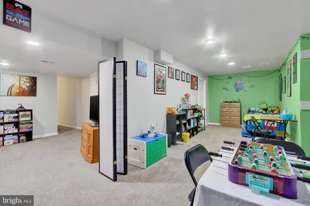 a view of a play room with furniture and toys