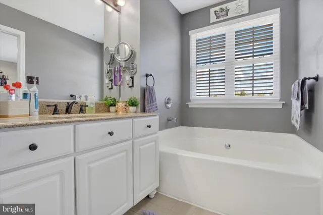 a bathroom with a shower sink and mirror