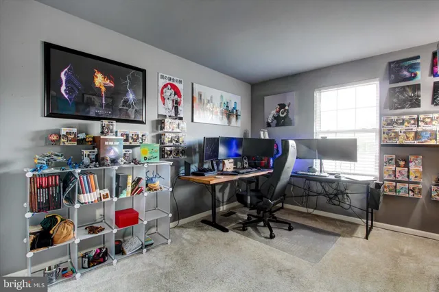 a view of a livingroom with workspace and a window