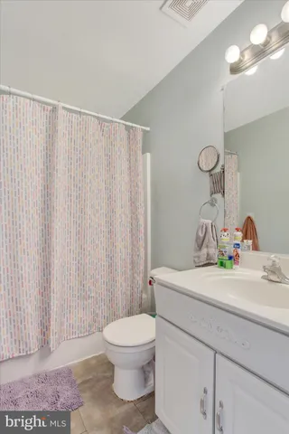 a view of a patio with chairs and potted plants