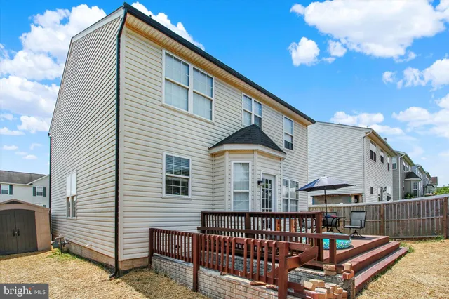 a view of a patio with table and chairs under an umbrella