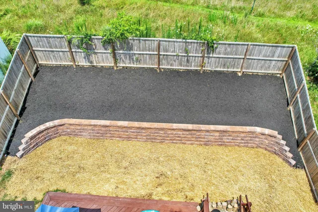a view of swimming pool with wooden fence