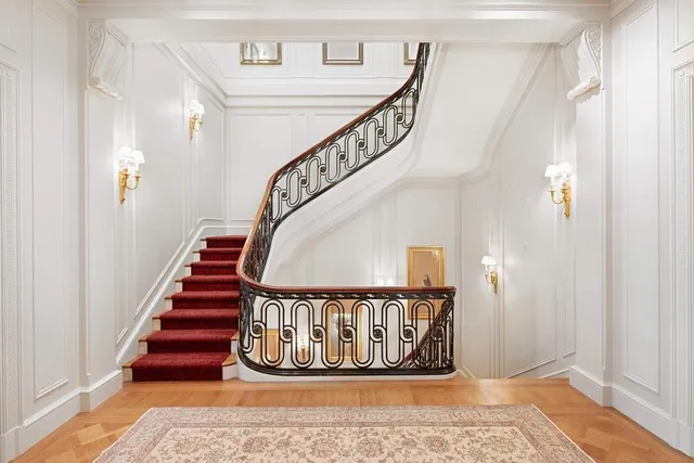 a view of a room with wooden floor potted plant and a chandelier