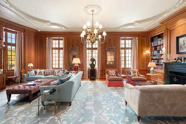 a living room with furniture and a chandelier